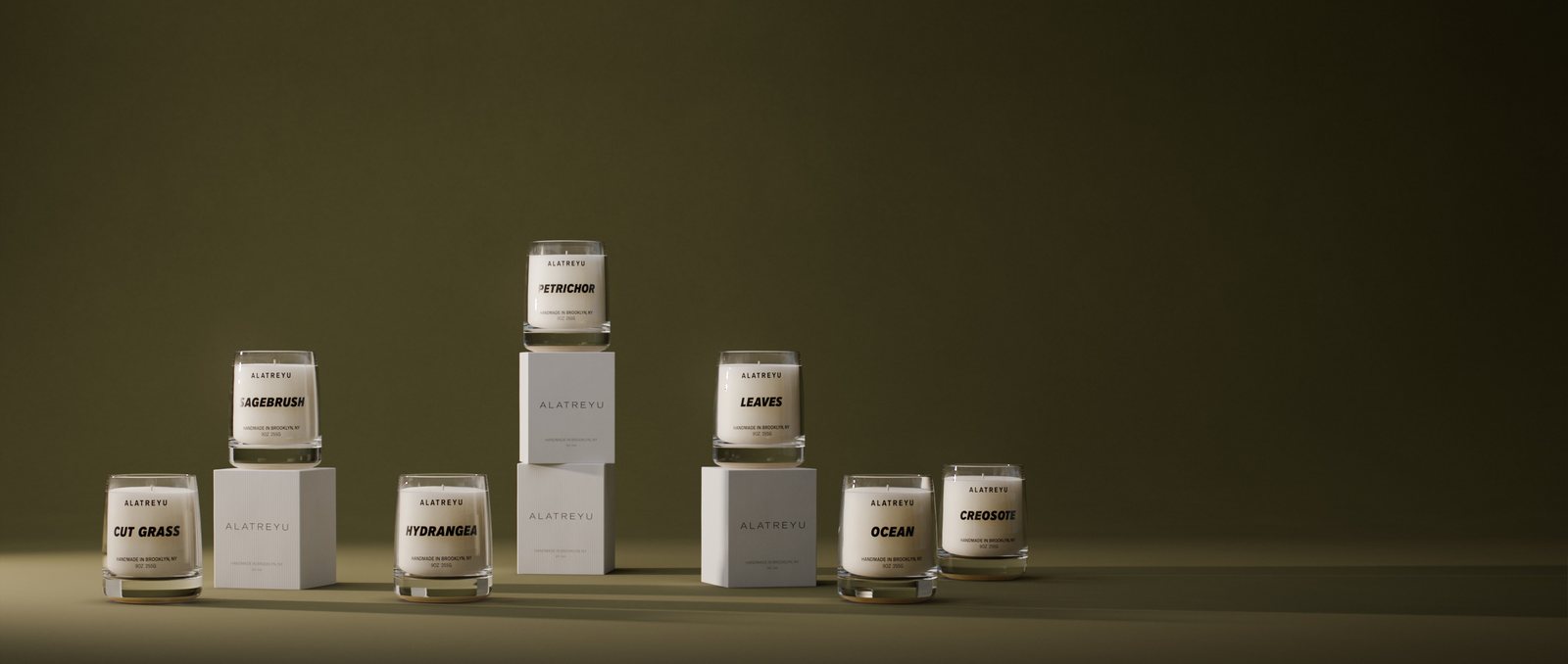A group of Alatreyu candles on a grey backdrop